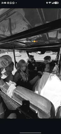 a group of people sitting in the back of a car