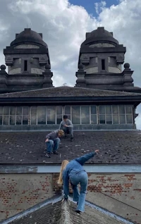 a group of people standing on the roof of an old building